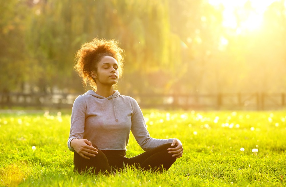 Young,African,American,Woman,Meditating,In,Nature
