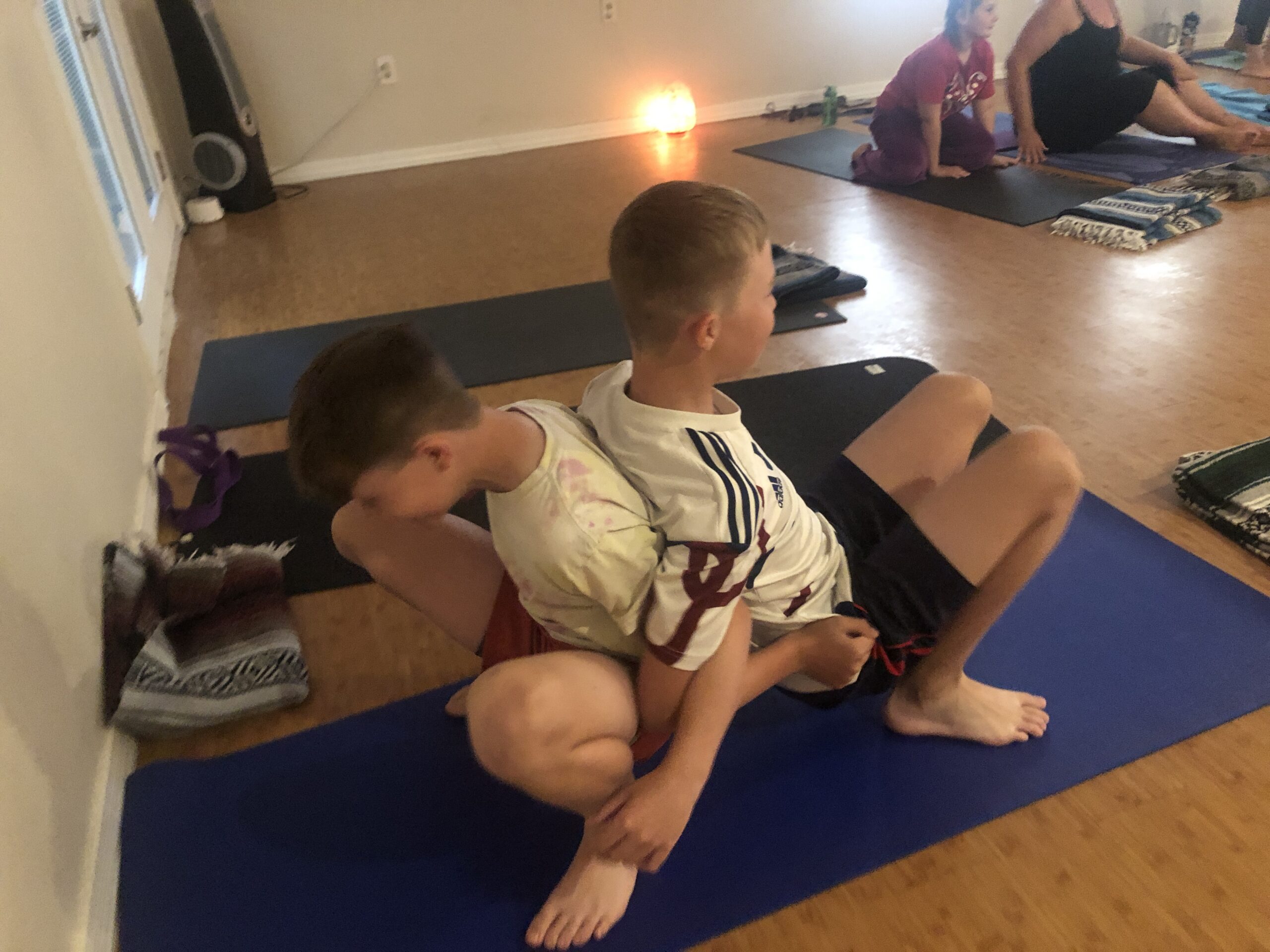 Kids doing yoga poses together in the ZenKids Yoga class